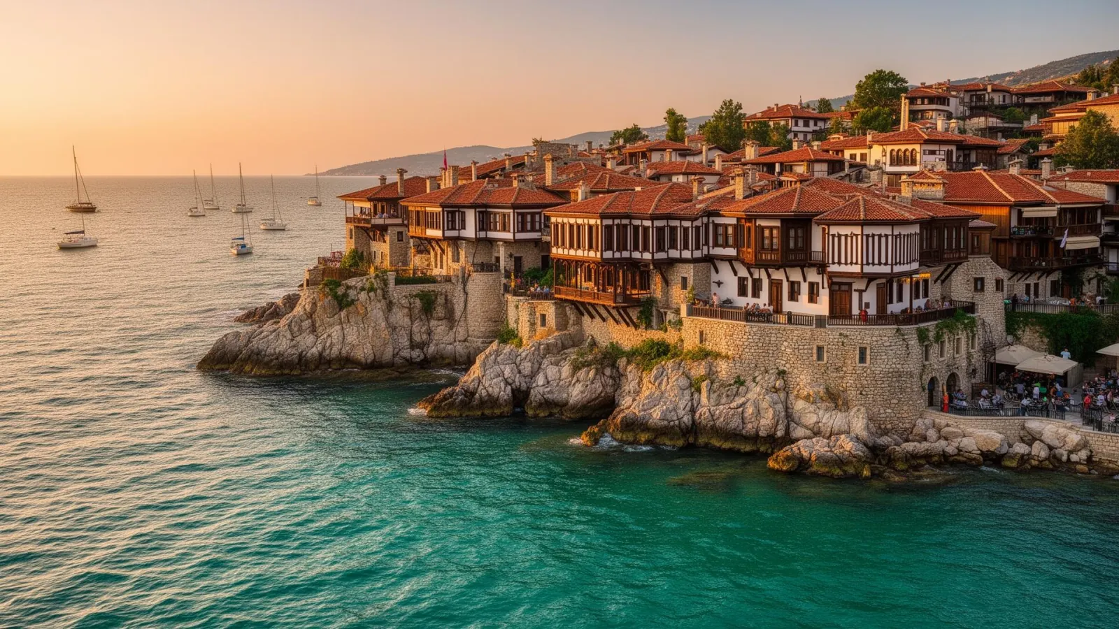 Wooden revival houses on Sozopol's old town peninsula above turquoise Black Sea bays